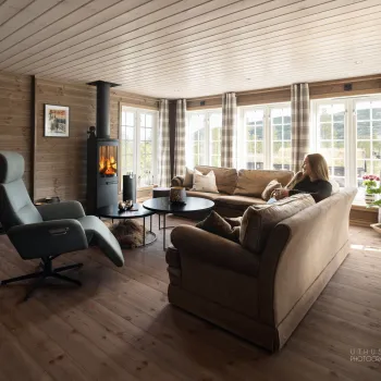 a person sitting on a couch in a room with a fireplace